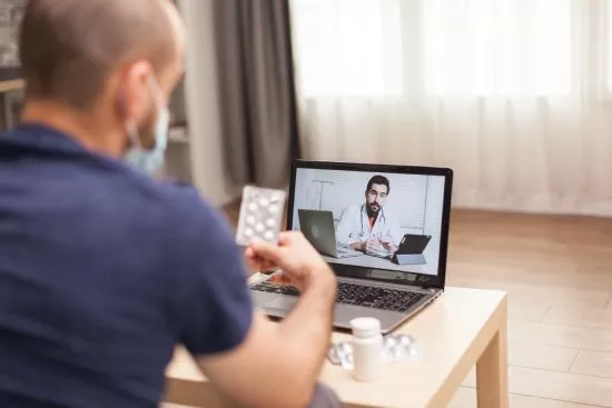 Patient having a telehealth consultation on a laptop